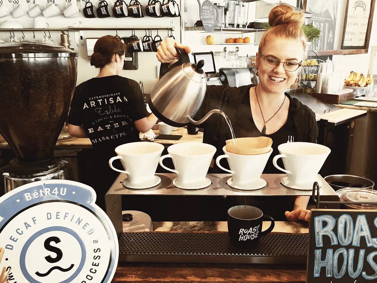Barista pouring over coffee at the EAT Marketplace SIP Bar